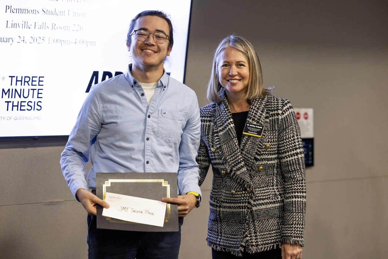 Sean Doherty receives his award for second place from Dr. Ashley Colquitt